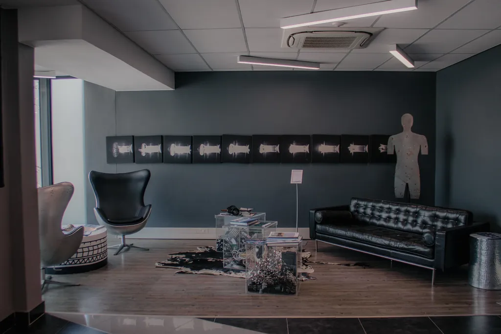Reception area inside CSIR Building 44 with dark walls and leather seating